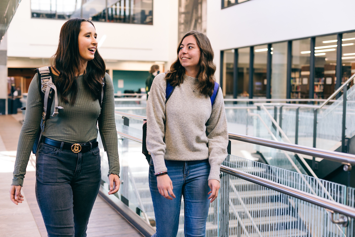 Two students walking in conversation
